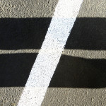 Shadows and white stripe form a not-equal-to sign.